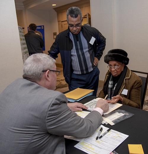 Dr. Tim McMahon (left), Armed Forces Medical Examiner System Department of Defense DNA Operations director, talks with Dorothy Britt, about family reference sample to see if she is eligible to donate DNA during a family member update in Birmingham, Alabama. The Defense POW/MIA Accounting Agency conducts periodic and annual government briefings for families of service members who are missing in action. These events are designed to keep family members informed of those still missing and to discuss in detail the latest information available about their specific case. (U.S. Air Force photo by Staff Sgt. Nicole Leidholm)