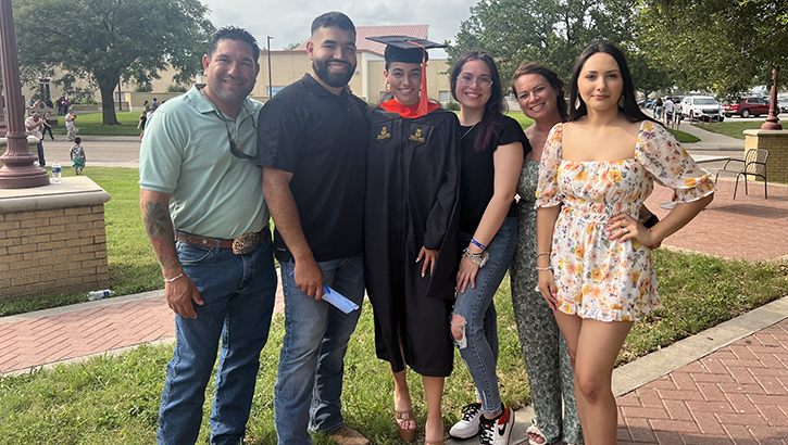 Madisyn Cardenas, center, is pictured with her family after a graduation ceremony for her sister Larissa Sanchez at Texas A&M University in Kingsville, Texas, on May 12. From left, dad Stephen Cardenas, brother Stevie Cardenas, sister Larissa Sanchez, Madisyn Cardenas, mother Jennifer Cardenas, sister Natalie Villarreal. Cardenas was severely injured in a roadside accident on Oct. 5, 2022 and brought to Brooke Army Medical Center for a groundbreaking procedure. (Photo Courtesy Department of Defense)