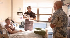  Col. William Bimson, commander of Tripler Army Medical Center, presented a gift basket to U.S. Army Capt. Henry Zenger and Capt. Cecilia Zenger following the birth of their son, Gus Zenger