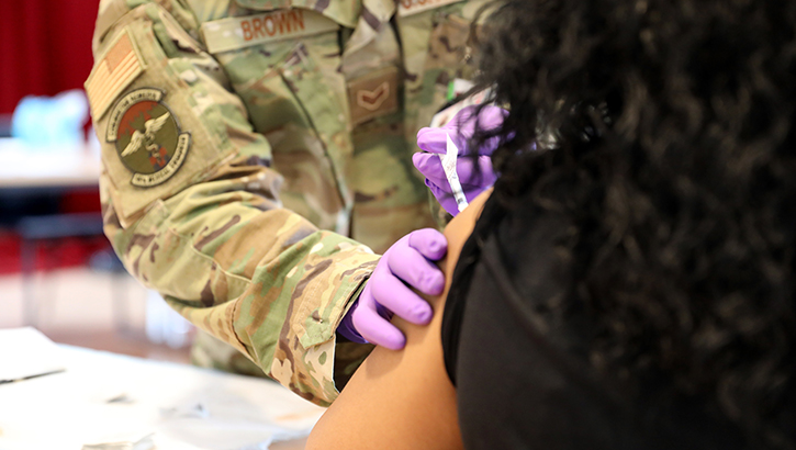 A person getting an injection on their arm.