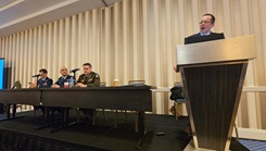 Dr. James Nash, dean of the Uniformed Services University's College of Allied Health Sciences, opens a panel discussion on artificial intelligence during the AMSUS annual meeting. Seated from left to right are panelists Air Force Maj. Nathan Stevenson, Lt. Col. Joshua Duncan, and Lt. Col. (Dr.) Brian Kirkwood. 