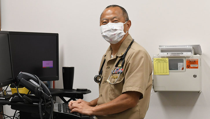 Image of A naval doctor works on the new MHS GENESIS EHR. Click to open a larger version of the image.