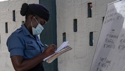 Ghanaian sailor taking notes while standing watch