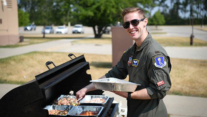 Military personnel grilling food 