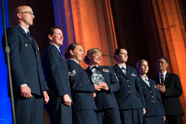 The 99th Medical Group, Nellis Air Force Base, Nevada receives the 2018 Heroes of Military Medicine Ambassador Award in Washington, D.C., May 3, 2018, for the life-saving efforts of three of its airmen during the tragic Las Vegas shooting on Oct. 1, 2017. Army Maj. Gen. (retired) Joseph Caravalho (right), president, Henry M. Jackson Foundation for the Advancement of Military Medicine presented the award to the 99th MG. (MHS photo)