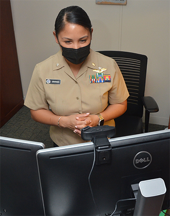 Woman servicemember in front of computer