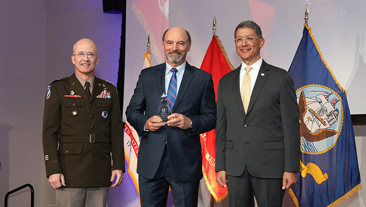 Image of Army Lt. Gen. (Dr.) Ron Place, Dr. Michael Helwig and Joseph Caravalho, Jr. posing for the photo.
