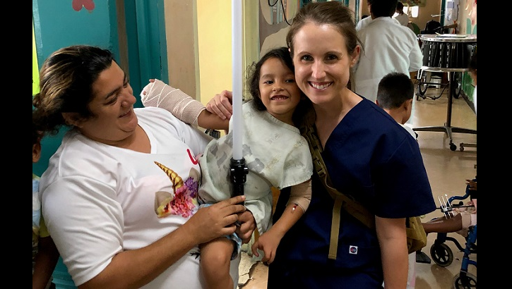 Air Force Maj. Julia Nuelle, chief of Orthopaedic Hand and Microvascular Surgery at Brooke Army Medical Center, poses for a photo with a pediatric patient and her mother during a Medical Readiness Exercise in Tegucigalpa, Honduras. The team finished their mission by visiting their patients and delivering toys and coloring books to the hospital's pediatric ward. (Courtesy photo by Army Lt. Col. Lori Tapley)