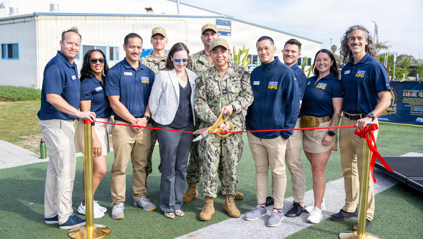 Navy Capt. Brian C. Bungay, Naval Base San Diego commanding officer, center, and base leadership are joined by Harborside Sports and Fitness Complex leaders during the grand opening of the Navy's first and only Human Performance Optimization Program