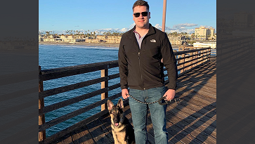 Petty Officer 3rd Class Logan Talbott gets exercise and fresh air when taking dog Odin on long walks. Here, they're at Oceanside Pier in California. (Courtesy photo)