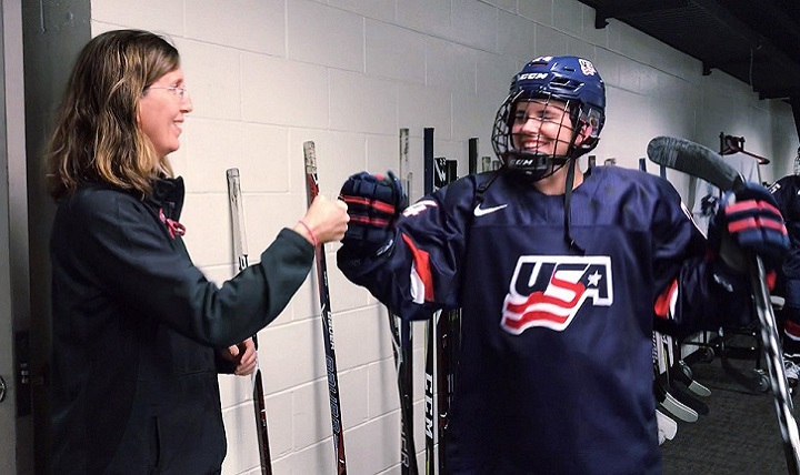 Dr. Allyson Howe fist bumps one of USA’s women’s ice hockey team members during the 2018 Winter Olympics in Pyeongchang, South Korea. (Photo courtesy of Allyson Howe)
