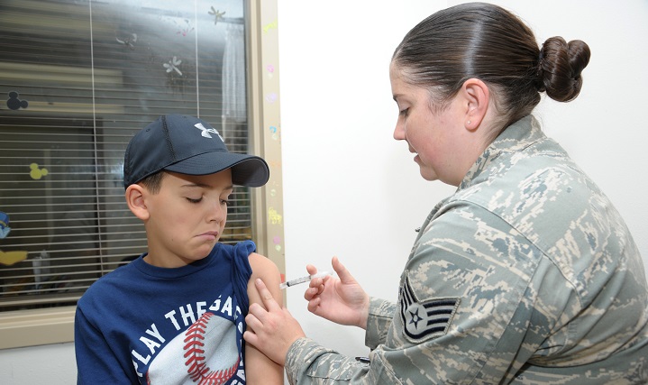 Staff Sgt. Alisha Slone, 359th Medical Group immunizations technician, immunizes Caiden Payne July 9, 2015, at the Joint Base San Antonio-Randolph Clinic. August is Immunization Awareness Month and provides an opportunity to highlight the value of immunizations, and focuses on encouraging all people to protect their health by vaccinating against infectious diseases.   (U.S. Air Force photo by Joel Martinez/Released)