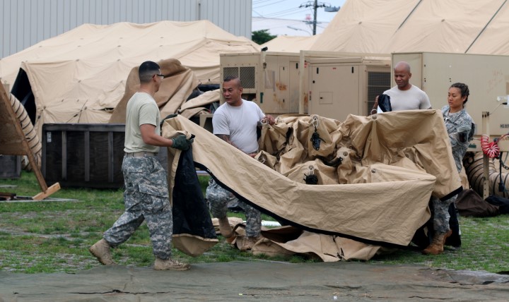 Soldiers break down a portion of a Deployable Rapid Assembly Shelter during an exercise in Japan. A new tool is helping medical personnel make sure soldiers are ready to deploy long before they arrive at any processing lines. (Photo by Army Staff Sgt. Chanelcherie DeMello)
