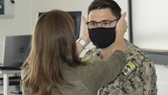 Military health personnel performing a balance test on a patient