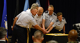 The Colorado Market establishment ceremony at Peterson Air Force Base, Colorado, on June 22, 2021, included a cake cutting with Air Force Col. Patrick Pohle, 21st Medical Group commander, left, Army Col. Kevin R. Bass, Evans Army Community Hospital commander and Colorado Market director, Army. Lt. Gen. (Dr.) Ronald J. Place, director of the Defense Health Agency, Air Force Col. Christopher Grussendorf, 10th Medical Group commander, and Air Force Col. Shannon Phares, 460th Medical Group. (photo by Airman Aaron Edwards).