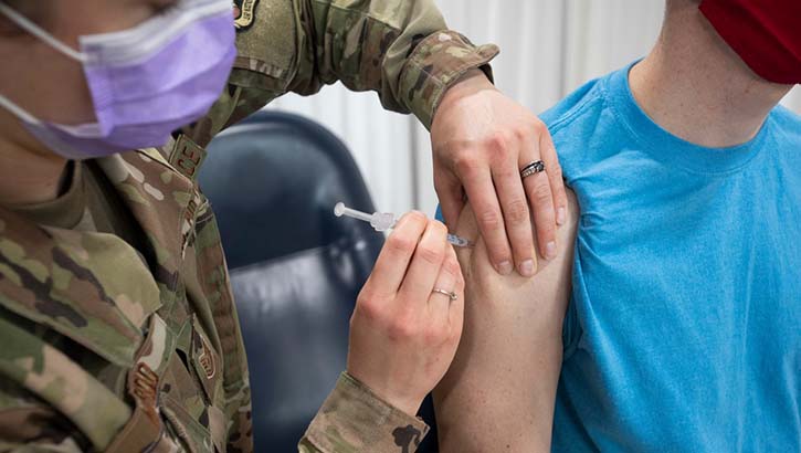 Military health personnel giving the COVID-19 vaccine