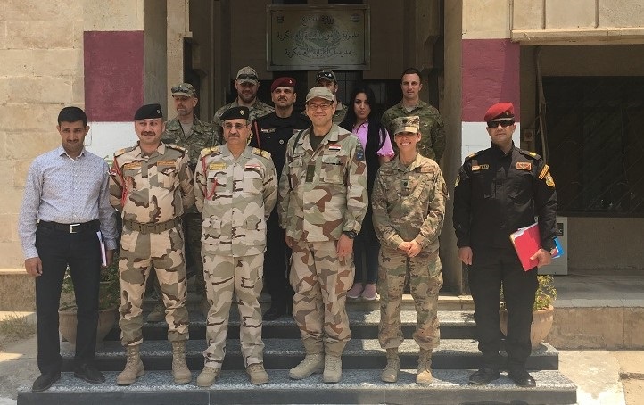 U.S. Air Force Lt. Col. Jessica Cowden, Infectious Disease Programs chief with the Defense Institute for Medical Operations, Joint Base San Antonio-Lackland, Texas, poses for a photo with the NATO Mission Iraq Embedded Training Team during the Combined Joint Task Force - Operation Inherent Resolve, June 25, 2019. (Photo By Josh Mahler)