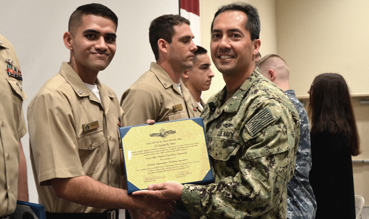 Navy Petty Officer 3rd Class Jovanei Taito, shown here receiving his information warfare qualification certificate, credits the ShipShape program for enabling him to pass the Navy's body composition and physical fitness assessments.  (Courtesy photo)