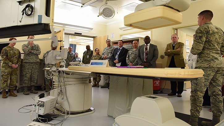 Air Force Staff Sgt. Matthew Slaven (right), 81st Medical Operations Squadron cardiopulmonary technician, briefs 81st Medical Group staff and guests on cath lab capabilities during the cardiac catheterization laboratory ribbon cutting ceremony inside Keesler Medical Center at Keesler Air Force Base, Mississippi. The lab was upgraded with an entire suite of technology to provide better and safer care for patients and the surgical team. (U.S. Air Force photo by Senior Airman Suzie Plotnikov)