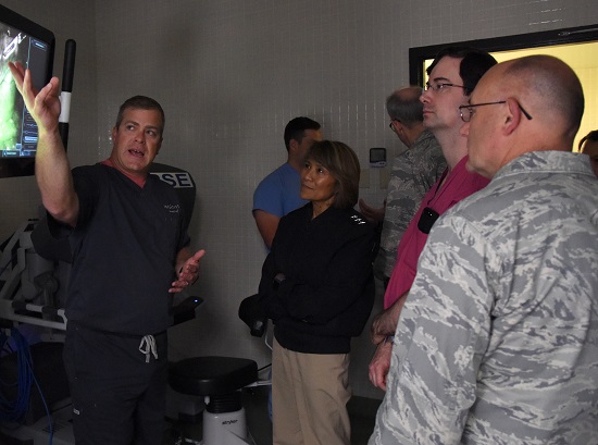 Greg Street, Intuitive Surgical instructor, left, briefs Navy Vice Adm. Raquel Bono, Defense Health Agency director, on the capabilities of robotics surgery at the Clinical Research Lab during a site visit at Keesler Air Force Base, Mississippi, April 27, 2018. The purpose of the visit was to get oriented with base operations and the Keesler Medical Center. The visit also included an office call with 2nd Air Force leadership and tours of Radiology Oncology and the newly renovated 81st Dental Squadron clinic. (U.S. Air Force photo by Kemberly Groue)
