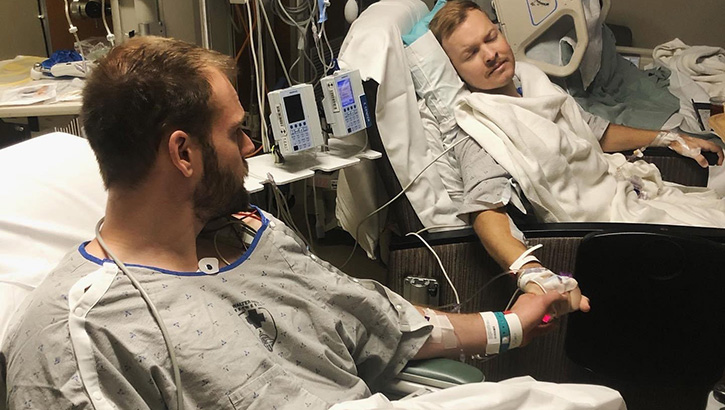 U.S. Navy Lt. Nathan Henderson (right), assistant public works officer at Naval Support Activity South Potomac, prays before kidney transplant surgery with his friend and donor, Taber Wanstall, at Walter Reed National Military Medical Center. (Photo by Regina Adams/NFESCW
