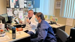 Military personnel looking at a computer