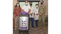 Hospital personnel standing with a cleaning robot