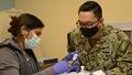 Military health personnel preparing to administer the COVID-19 vaccine