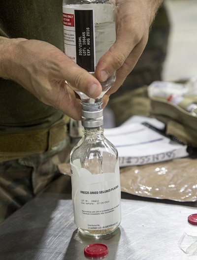 Critical Skills Operators reconstitute freeze-dried plasma during an exercise. CSOs go through a condensed version of FDP training to familiarize themselves with the product for use in the field. (U.S. Marine Corps photo by Sgt. Salvador R. Moreno)