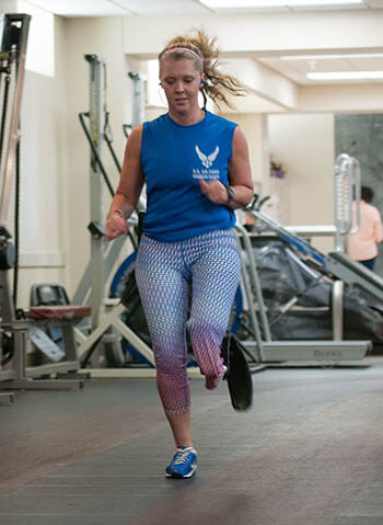 Retired Senior Airman Heather Carter, an above-knee amputee, runs laps around a track inside the Military Advanced Training Center at Walter Reed National Military Medical Center in Bethesda, Maryland. Carter and other amputees receive physical and occupational therapy at the center as they work toward their goals. One of Carter’s goals is to return to competitive softball. (Photo: Sean Kimmons, U.S. Air Force)