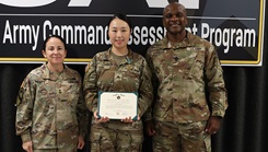 U.S. Army Sgt. Minjin Choi, stands with U.S. Army Human Resources Commanding General, Maj. Gen. Hope C. Rampy and Command Sergeant Major, Command Sgt. Maj. Robert Atkinson after receiving an Army Commendation Medal for her actions in assisting with a life-threatening emergency during CAP26. (Courtesy Photo)