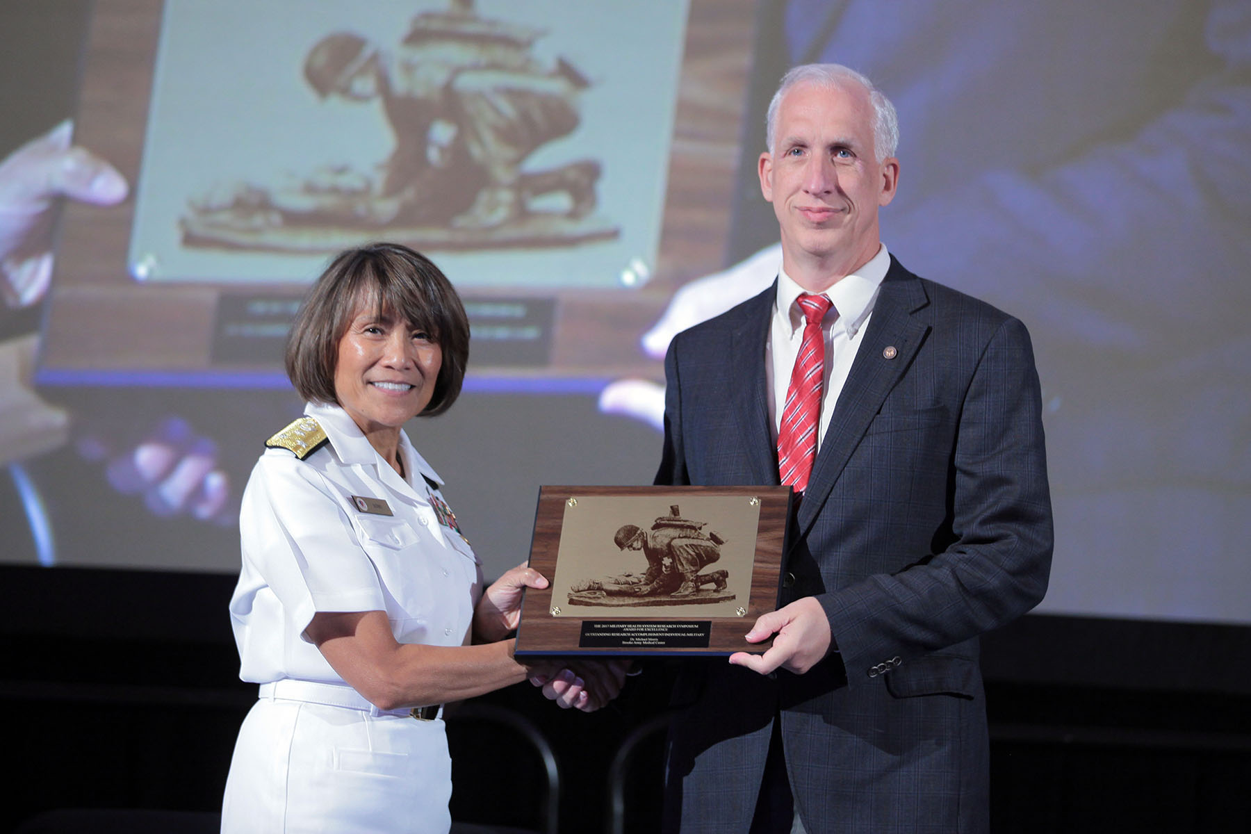 Vice Admiral Raquel C. Bono, director of the Defense Health Agency, presented Michael J. Morris, M.D. with the 2017 Individual Research Accomplishment for civilians, in the category of Occupational Medicine, today at the Military Health System (MHS) Research Symposium. The Individual Research Accomplishment award recognizes outstanding contributions by an individual scientist that had a high impact on MHS research within the past year.  Morris is recognized today for his ongoing research investigating the effects of deployment on respiratory health.