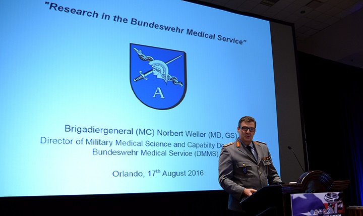 Brig. Gen. Norbert Weller, director of Military Medical Science and Medical Service Capability Development for the German Army Medical Service Academy in Munich, Germany, presents the International Distinguished Lecture to open Day 3 of the MHS Research Symposium. 