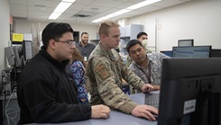 military personnel at computer monitor