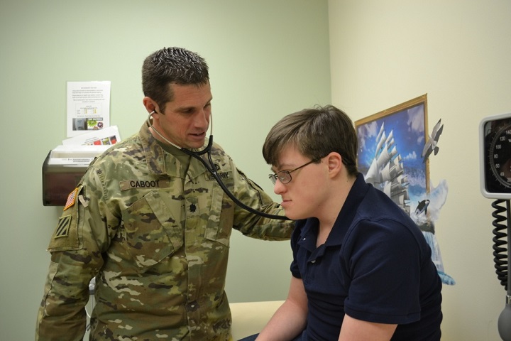 Army Lt. Col. (Dr.) Jason Caboot, pediatric pulmonologist, Madigan Army Medical Center, examines Jacob Schaff, an established pediatric specialty care patient at Naval Hospital Bremerton, Washington. The Schaff’s often find themselves traveling throughout the Puget Sound area to seek the specialty care Jacob requires. (U.S. Navy photo by Emily Yeh)