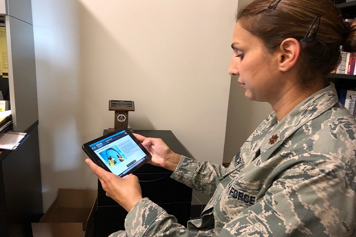 Maj. Malisha Martukovich, Air Force liaison for the DoD Hearing Center of Excellence, tests out the new HEAR course app, which can be downloaded onto a smartphone or tablet for convenient access. (DoD HCE photo)