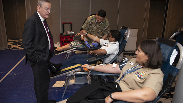 Dr. Lester Martínez-López, assistant secretary of defense for health affairs, visits with blood donors during the 2024 Defense Health Information Technology Symposium in Dallas in August. Martinez retires from his position Oct. 31. In the last interview before his retirement, he shares his experience, vision for the Military Health System, and his passion for enhancing warfighter health. 