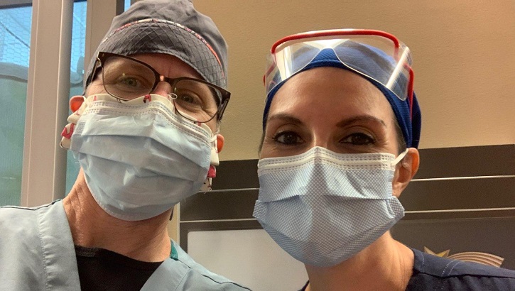 Image of Two military healthcare workers wearing masks. Click to open a larger version of the image.