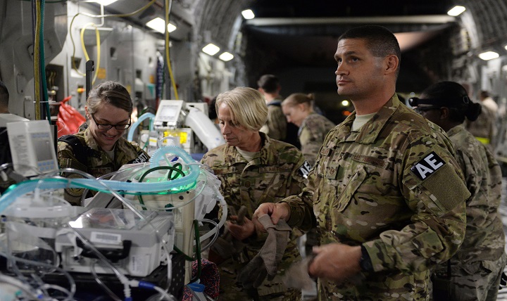North Carolina Air National Guard Tech. Sgt. Russell McLamb (right), an aeromedical evacuation technician, helps load an injured service member onto a C-17 Globemaster III on the flight line at Bagram Airfield, Afghanistan. 