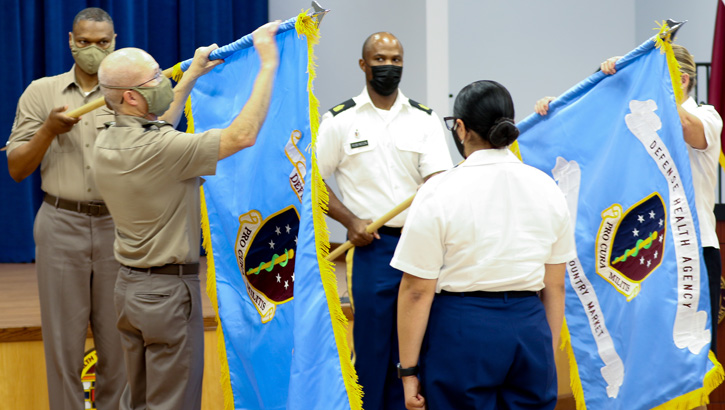 Image of Military personnel uncasing the DHA Low Country Market colors.