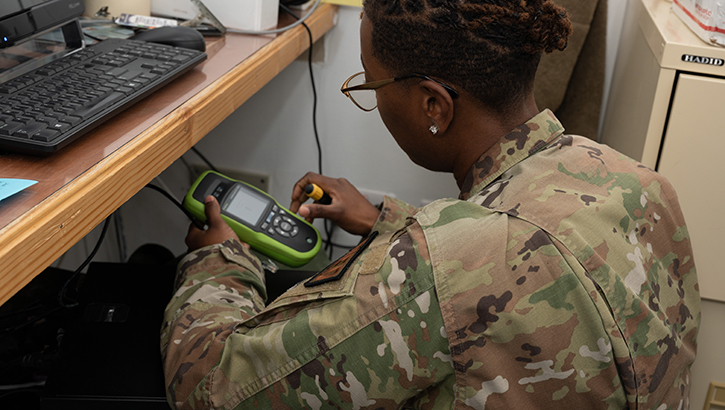U.S. Air Force Senior Airman Andrea President, a medical information service systems technician, 379th EMDSS, demonstrates using a cable testing device at the 379th EMDG radiology lab at Al Udeid Air Base, Qatar. (Photo by U.S. Air Force 1st Lt. Bayard Lewis) 
