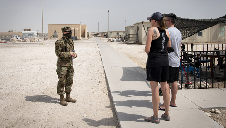 Image of U.S. Air Force Tech. Sgt. Nathan Davis, conducts a weekly Disaster Mental Health battlefield circulation walk around Quarantine Town.