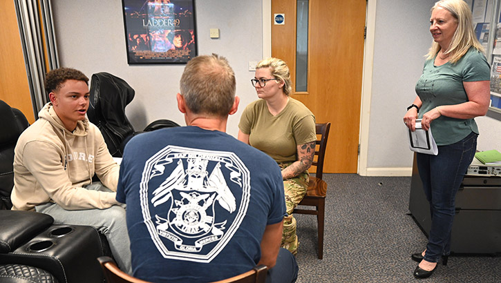 From left to right: Kelcy Pryor, Ensign Timothy Pryor, assigned to 1st Medical Battalion, Juanita Pryor, mother of Timothy Pryor, and U.S. Navy Command Master Chief Zachary Pryor, command master chief of Naval Medical Forces Atlantic, pose for a group photo during a commissioning ceremony on the flight deck of the USS Midway Museum on July 11, 2023.  (Photo: U.S. Navy Lt. Corey Smith) 