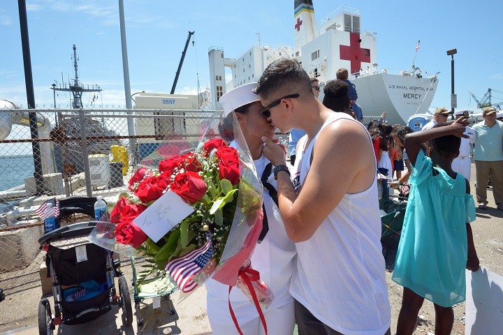 Navy Hospital Corpsman Tianna Garcia, assigned to Naval Medical Center San Diego, is greeted by her husband Aaron Garcia during the homecoming ceremony for the hospital ship USNS Mercy. The ship and her crew completed a five-month humanitarian relief mission to Southeast Asia. (U.S. Navy photo by Mass Communication Specialist 2nd Class Indra Beaufort)
