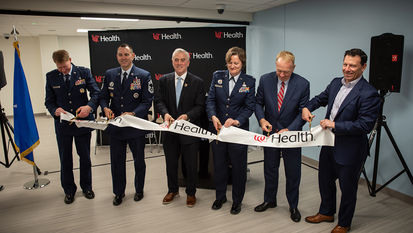 From left: Brig. Gen. Robert Bogart, commander of the 711th Human Performance Wing; Chief Master Sgt. James Woods, medical enlisted force and enlisted corps chief, Office of the Surgeon General; Brad Wenstrup, former U.S. Rep. of Ohio; Col. Valerie Sams, director of the Center for Sustainment of Trauma and Readiness Skills (C-STARS) Cincinnati, U.S. Air Force, and trauma surgeon at University of Cincinnati (UC) Medical Center; Dr. Greg Postel, dean of the UC College of Medicine; and Cory Shaw, president and CEO of UC Health, cut the ribbon