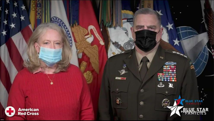 Mr. and Mrs. Milley, wearing masks, standing in front of various flags.