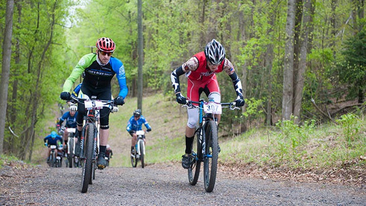 Image of People biking on a trail in protective gear.