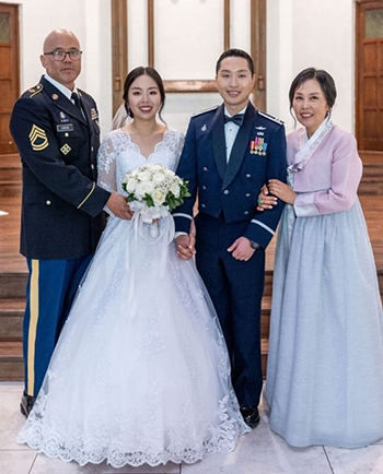 U.S. Army Sgt. 1st Class David Hong and his wife Monica pose with their daughter and son-in-law. 