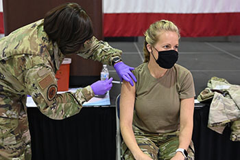 Military personnel receiving the COVID-19 vaccine