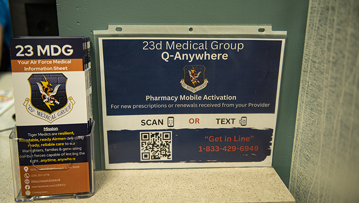 A flyer for the new texting option for prescription activation sits in the lobby of the 23rd Medical Group Pharmacy at Moody Air Force Base, Georgia, Dec. 15, 2023. The Q-Anywhere option lets you either scan the QR code or send a text to begin the activation process for a new prescription. (Photo by U.S. Air Force Airman 1st Class Whitney Gillespie) 